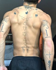 a man with many tattoos on his back