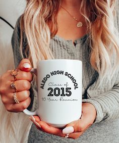 a woman holding a white coffee mug with the words, no high school class on it