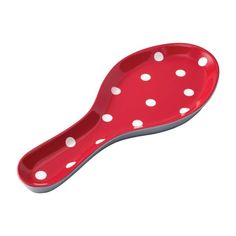 a red spoon with white polka dots on it