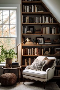 a living room filled with lots of books on top of a book shelf next to a window