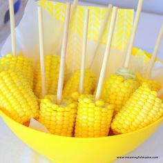 corn on the cob with toothpicks in a yellow bowl