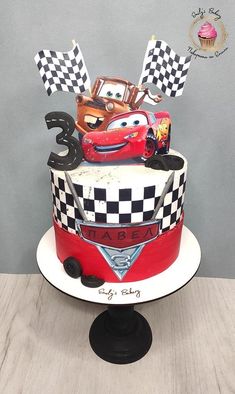 a birthday cake decorated with cars and numbers