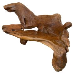 a wooden bench that is shaped like a dog on it's back legs and feet