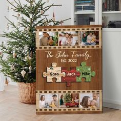 a wooden puzzle with photos on it next to a christmas tree