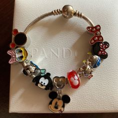 Retired Authentic Pandora Disney Mickey Mouse Cz Clasp Snake Moment Bracelet With 10 Brand New Disney Themed Charms 925 Sterling Silver Bracelet. Bracelet Is 100% Authentic Pandora. Great Condition. Rare Discontinue Hard To Find As A Tribute To The World's Most Famous Disney Character, This Version Of Pandora's Classic .925 Sterling Silver Charm Bracelet Features An Embellishment Of Sparkling Mickey Silhouettes. It Represents The Perfect Starting Point For Your Disney Collection. Pandora Disney,