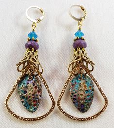 Hand-Painted Earrings. The centerpiece of these earrings are the beautiful hand-painted on copper with resin charms made by Washington State artist Kristi. I accented them with rounded triangle connectors, vintage brass bead caps, purple faceted Czech glass beads and turquoise Swarovski crystal bicone beads. These earrings are 3 inches long including the pure brass round lever back closures. One Of A Kind I can send it gift wrapped (free of charge), if requested. Handmade Bronze Czech Glass Earrings, Bohemian Enamel Earrings Nickel-free, Nickel-free Bohemian Enamel Earrings, Bohemian Enamel Earrings Nickel Free, Handmade Bronze Brass Teardrop Earrings, Bohemian Gold Earrings With Patina, Nickel-free Bronze Artsy Earrings, Gold Bohemian Earrings With Patina, Bohemian Hand-painted Copper Jewelry