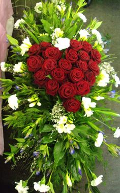 a large bouquet of red roses and white flowers