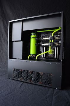 the inside of a computer case with green pipes and wires in it on a black background