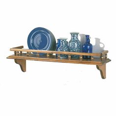 a wooden shelf with plates and vases on it