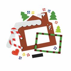 a gingerbread house cut out from paper with candy canes and christmas decorations around it