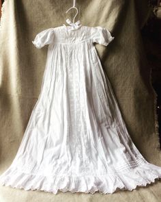 "For Your Consideration... Simple Elegant Victorian Christening Gown Classic Family Heirloom Hand Made Gossamer fine all cotton w/lace Measures 34 inches from shoulder to hem. Shoulder 11\" across Sleeves 5 inches long Waist measure 17.5inches. SizeAprox up to 6months. Due to the vintage nature of this item, it has no size tag so please use the measurements provided to determine the sizing. No signs of yellowing with age. I found a few amazing gowns while on a recent trip to la Belle France... A Victorian Cotton Dress With Historical Design, Regency Style Fitted Gown With Lace Trim, Classic White Cotton Victorian Dress, Fitted Cotton Prairie Dress For Weddings, Vintage Cotton Dress With Historical Design, Fitted Cotton Wedding Gown, Historical Cotton Victorian Dress For Wedding, Victorian Cotton Wedding Dress With Ruffles, Historical Cotton Victorian Wedding Dress