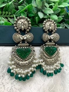 Black metal oxi jhumki earring. About 5.5 inch long and 2 inch wide. Light weight, pachi kundan work in emerald green. Pearl details. Luxury Festive Peacock Chandbalis, Luxury Chandbali Danglers With Meenakari, Luxury Green Chandbalis In Fusion Style, Luxury Traditional Chandbalis For Navratri, Luxury Green Meenakari Jhumkas, Punjabi Traditional Jewellery, Kundan Work, Diamond Mirror, Chandbali Earrings