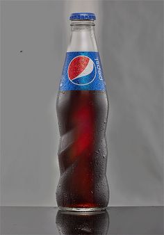 a bottle of pepsi soda sitting on top of a table