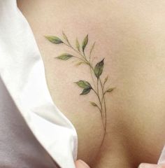 a woman's back with leaves on it