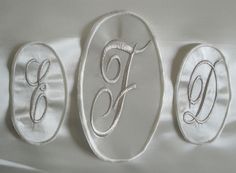 three oval embroidered monograms with the letter f on them