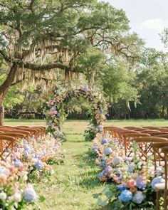 an outdoor ceremony setup with chairs and flowers