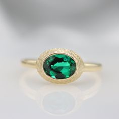 "Handmade by an inspired jewelry artist team with decades of experience in the craft of jewelry making. Each gemstone, each diamond is carefully picked. Using only the finest raw materials and the highest industry standard in manufacturing, design and finish. This vintage inspired ring is set with a luxurious green Emerald in a handmade hammered frame The contrast between the rough frame and the fine cut gemstone is what makes this ring so unique! Set with a 8X6 Chatham Green Emerald 1.21 ct All Hammered Oval Wedding Rings, Oval Hammered Jewelry For Wedding, Oval Hammered Wedding Jewelry, Oval Hammered Wedding Rings, Handmade Heirloom Emerald Ring, Heirloom Recycled Gold Hammered Rings, Heirloom Hammered Rings In Recycled Gold, Heirloom Yellow Gold Emerald Cabochon Ring, Handmade Classic Luxury Emerald Ring