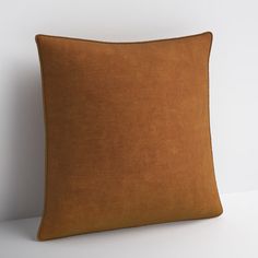 a brown pillow sitting on top of a white table