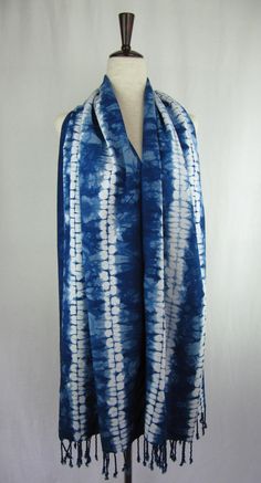 a blue and white tie dyed scarf on a mannequin