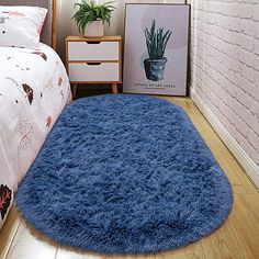 a bedroom with a bed and a blue rug on the floor