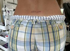 a woman with a tattoo on her lower back