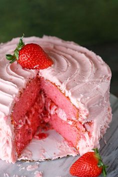 a strawberry cake with one slice missing from it