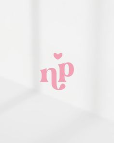 the word n p is written in pink on a white surface with a small heart