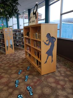 there are many books on the shelves in the library with blue shoes scattered around them