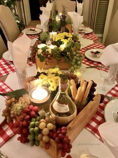 the table is set with wine, cheese and crackers for an appetizer