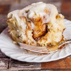 a piece of cinnamon roll on a plate with a fork