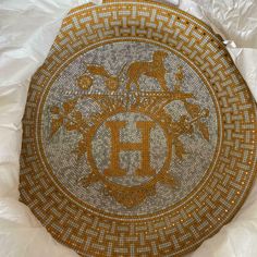 a decorative plate with the letter h on it