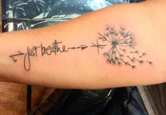 a dandelion tattoo with the words just breathe and an arrow pointing to it