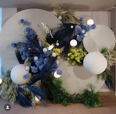 an arrangement of blue and white flowers on display