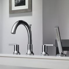 a bathroom sink with two faucets and soap dispenser