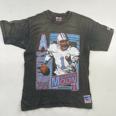 - Tagged Large - Measures 20” across 26” long - 100% Cotton - Made in USA, Single Stitch - Faded black - Overall great worn condition - Message me for more information Vintage Graphic Print T-shirt For Sports Events, Vintage Graphic Print T-shirt For Football Season, Nfl Graphic Tees, Warren Moon, American Football Shirt, Vintage Nfl Shirts, Texans Logo, Vintage Nfl Jersey, Houston Oilers