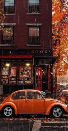 an orange car parked in front of a book store