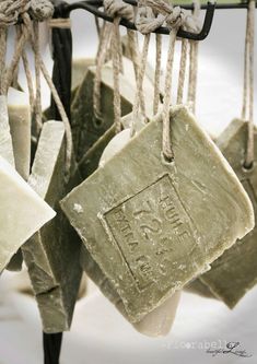 soaps hanging from a rope with tags attached to them