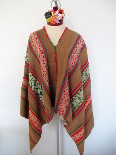 This Poncho is absolutely beautiful and warm, perfect  for the winter and autumn seasons because its fiber is highly warm. This  poncho is brought from Pisac Cusco Peru. It is handwoven by Peruvian artisans with 100% Alpaca in the traditional Andean Method and is a naturally dyed blend of Alpaca, llama and sheep wool. It is a unique garment.  Material: Alpaca blend Measurements: 46x46 inches Will fit people sizes ranging from medium to large.  Color: Brown, beige, red and green. Weight: 2.15 pounds Made in Peru Artisan Winter Poncho For Festival, Traditional Handwoven Poncho For Fall, Artisan Alpaca Poncho For Fall, Brown Alpaca Cape Poncho, Brown Alpaca Poncho Cape, Handwoven Brown Poncho For Winter, Handwoven Brown Poncho For Fall, Bohemian Handwoven Poncho For Winter, Artisan Poncho For Fall