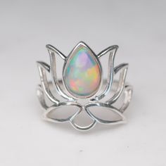 The Lotus flower is regarded in many different cultures, especially in eastern religions, as a symbol of purity, enlightenment, self-regeneration and rebirth. Its characteristics are a perfect analogy for the human condition: even when its roots are in the dirtiest waters, the Lotus produces the most beautiful flower. Opal is nature's rainbow, born deep in the earth, and the perfect distraction as you will not be able to keep your eyes off these beauties! Ethiopian Opals are world renowned for t Eastern Religions, Most Beautiful Flower, Rock Rings, The Human Condition, Lovers Necklace, Lotus Blossom, Different Cultures, Most Beautiful Flowers, The Lotus