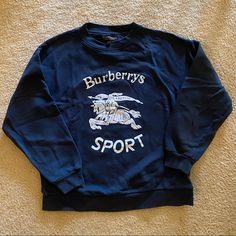 Authentic Burberry Crew Neck Sweatshirt. Navy Blue With White Lettering. Marked As A Unisex Size Small But Fits More Like A Women’s Xs In My Opinion. Measurements Are Provided And Can Provide Any Additional Measurements Upon Request. No Holes, Rips Or Stains. Burberry Tops, Burberry, Crew Neck Sweatshirt, Navy Blue, Blue And White, Womens Tops, Sweatshirts Hoodie, Crew Neck, Navy