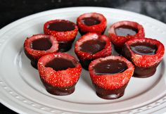 chocolate covered strawberries are arranged on a white plate