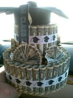 a stack of stacks of money with graduation caps on top, and dollar bills in the middle