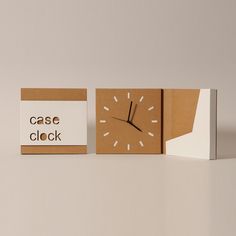 two pieces of cardboard with a clock on the front and one piece of yellow paper that says case closed