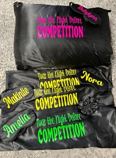 three black bags with writing on them sitting on the floor next to each other,