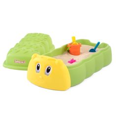 a yellow and green toy boat with sand in it