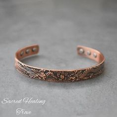 Embrace timeless elegance and natural healing with our Pure Copper Bracelet. This adjustable vintage bangle features a stunning Dragon and Phoenix design, symbolizing strength and harmony. Crafted from 100% pure copper, known for its therapeutic & healing properties, this bracelet offers benefits such as improved circulation, reduced inflammation, and relief from joint pain, Arthritis, boost your energy and overall immune system. The magnetic elements embedded in the band enhance these benefits, Dragon Phoenix, Phoenix Design, Vintage Dragon, Vintage Bangles, For Her Gifts, Functional Accessories, Copper Bracelet, Wellness Gifts, Pure Copper