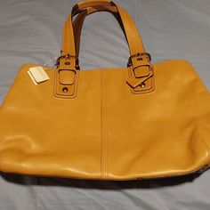 18 In. Width 11 1/2 Length Without Straps With Handles 10 In More In Length Bnwt Coach Tan Leather Large Purse,,Beautiful Color N Great 4 Whatever U Got Going On.,.Has A Few Scratches N Marks Shown In Pics But Nothing Really Bad..Still Brand New With Tag...Check Out Pics N If You Have A Question Please Feel Free To Ask Me...Great Deal N Offers R Welcome Always.. Elegant Yellow Bag For Work, Elegant Yellow Workwear Bag, Black Leather Satchel, Carryall Tote, Hippie Bags, Top Handle Handbags, Leather Bucket, Satchel Purse, Handbag Straps