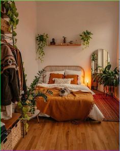 a bed sitting in a bedroom next to a mirror and potted plants on the wall