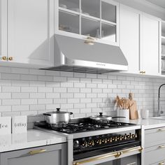 a stove top oven sitting inside of a kitchen next to white cupboards and counter tops