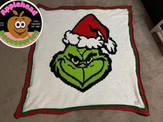 the grin face has been crocheted into a christmas blanket